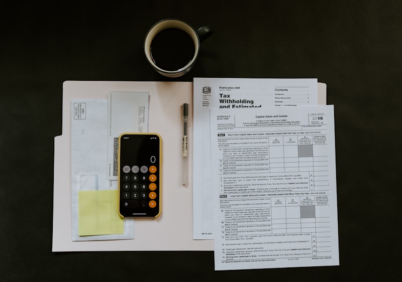 Tax return forms, a calculator and working papers on an accountant's desk